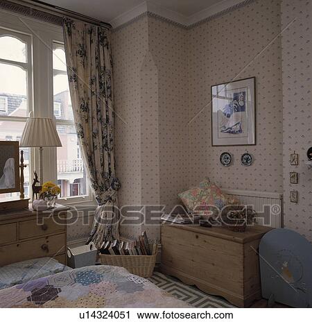 Blue+white curtains at sash windows in bedroom with blue+white wallpaper and antique pine chest View Large Photo Image Stock Image - Blue+white curtains at sash windows in bedroom with blue+white wallpaper and antique pine chest. Fotosearch