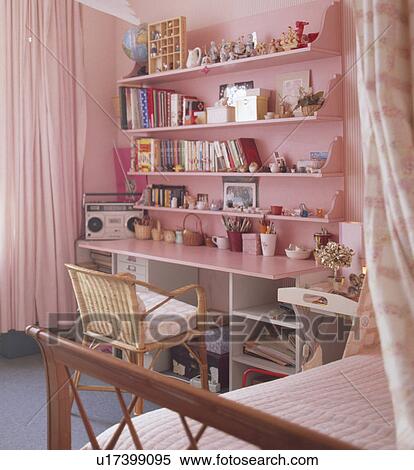 Books and knick-knacks on pink shelves beside bed in teenage girl's bedroom View Large Photo Image Stock Photography - Books and knick-knacks on pink shelves beside bed in teenage girl's bedroom. Fotosearch