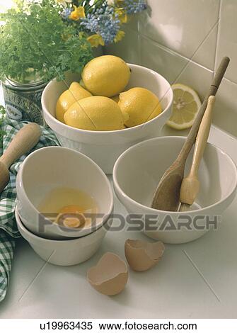 Bowl of lemons and bowl of cracked eggs with wooden spoon View Large Photo Image Stock Photography - Bowl of lemons and bowl of cracked eggs with wooden spoon. Fotosearch
