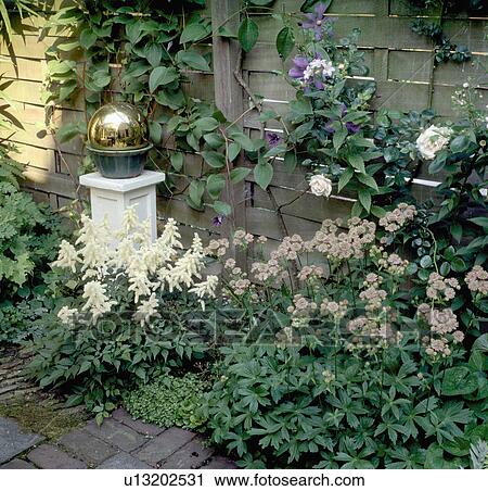 Brass globe on plinth in flower border in town garden in summer View Large Photo Image Stock Image - Brass globe on plinth in flower border in town garden in summer. Fotosearch