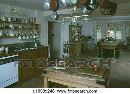 Stock Photograph - Butcher's block in traditional kitchen with freestanding cupboards. Fotosearch