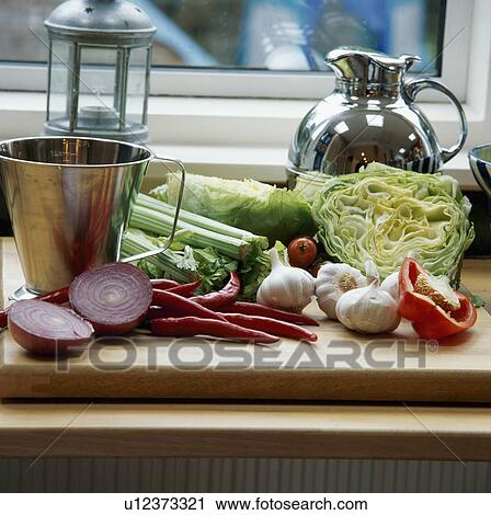 Cabbage and onions with other fresh vegetables on wooden chopping board with aluminium jug View Large Photo Image Stock Image - Cabbage and onions with other fresh vegetables on wooden chopping board with aluminium jug. Fotosearch