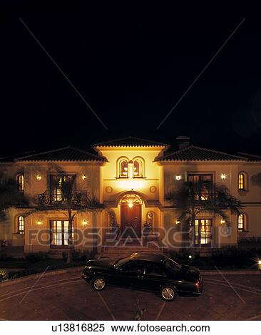 Car on drive in front of large villa lit at night in Southern Spain View Large Photo Image Stock Photography - Car on drive in front of large villa lit at night in Southern Spain. Fotosearch