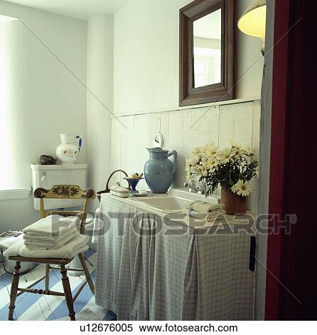 Checked curtains below basin in white country bathroom with pile of white towels on wooden chair View Large Photo Image Stock Photography - Checked curtains below basin in white country bathroom with pile of white towels on wooden chair. Fotosearch