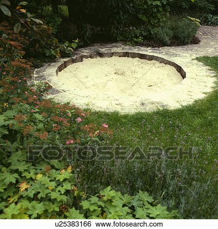 Circular sandpit with paved edging in children's play area in garden View Large Photo Image Stock Photograph - Circular sandpit with paved edging in children's play area in garden. Fotosearch