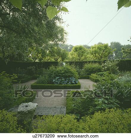 Clipped hedges in formal country garden in summer View Large Photo Image Stock Photo - Clipped hedges in formal country garden in summer. Fotosearch