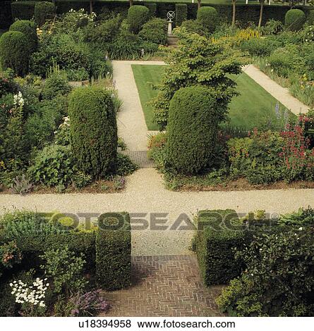 Clipped shrubs and gravel paths in large country garden in summer View Large Photo Image Stock Photo - Clipped shrubs and gravel paths in large country garden in summer. Fotosearch