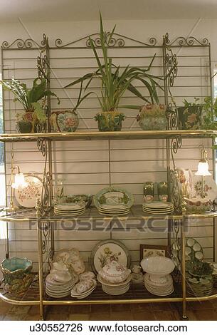 Close-up of antique china on ornate metal shelves View Large Photo Image Stock Photograph - Close-up of antique china on ornate metal shelves. Fotosearch