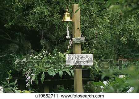 Close-up of bell on post in country garden View Large Photo Image Stock Image - Close-up of bell on post in country garden. Fotosearch