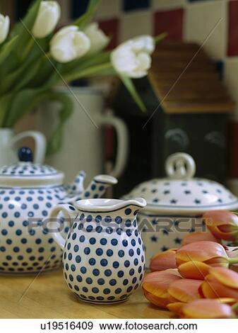Stock Photo - Close-up of blue+white spotted jug and teapot with matching dish. Fotosearch