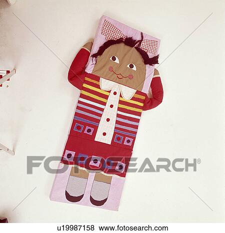 Close up of childs cushion mat in the shape of a doll View Large Photo Image Stock Photo - Close up of childs cushion mat in the shape of a doll. Fotosearch