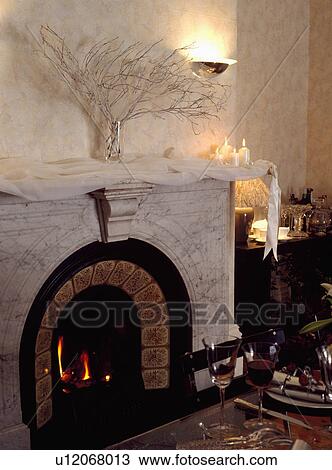 Close-up of Christmas branches and candles on marble fireplace with lighted fire View Large Photo Image Stock Image - Close-up of Christmas branches and candles on marble fireplace with lighted fire. Fotosearch