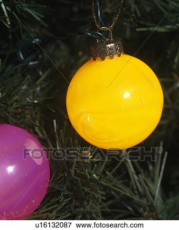 Stock Photo - Close-up of circular yellow and pink Christmas tree lights. Fotosearch