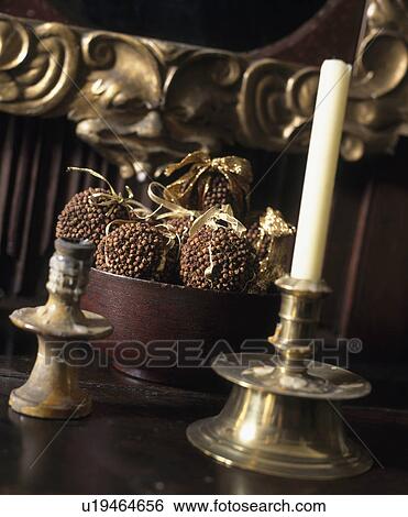 Close-up of clove pomander and white candle in brass candlestick View Large Photo Image Stock Photograph - Close-up of clove pomander and white candle in brass candlestick. Fotosearch