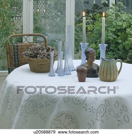 Close-up of collection of blue glass vases with small bust and lighted candles on white lace tablecloth View Large Photo Image Stock Photo - Close-up of collection of blue glass vases with small bust and lighted candles on white lace tablecloth. Fotosearch