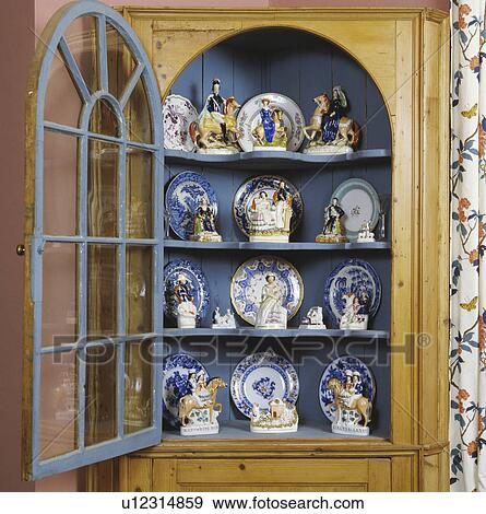 Close-up of collection of Staffordshire ornaments in antique glass-fronted cupboard View Large Photo Image Stock Photo - Close-up of collection of Staffordshire ornaments in antique glass-fronted cupboard. Fotosearch