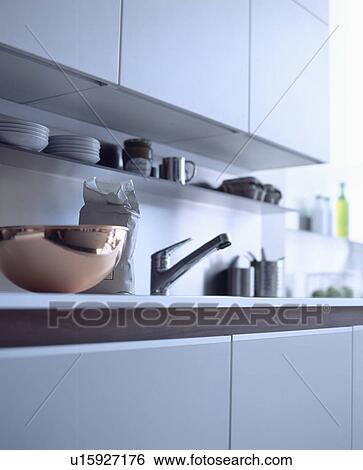 Close-up of copper bowl beside stainless steel tap in modern white kitchen View Large Photo Image Stock Photograph - Close-up of copper bowl beside stainless steel tap in modern white kitchen. Fotosearch
