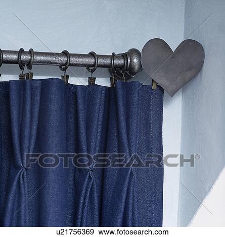 Close-up of dark blue curtain on metal curtain pole with heart shaped finial View Large Photo Image Stock Photo - Close-up of dark blue curtain on metal curtain pole with heart shaped finial. Fotosearch
