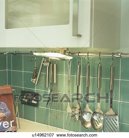 Close-up of electric plug and stainless steel utensils on green tiles in modern kitchen View Large Photo Image Stock Photo - Close-up of electric plug and stainless steel utensils on green tiles in modern kitchen. Fotosearch
