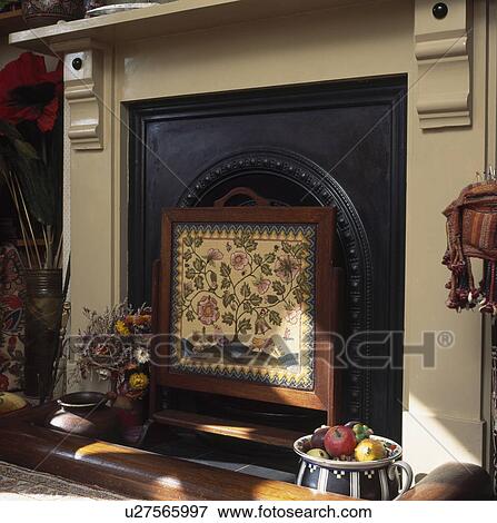 Close-up of embroidered firescreen in cream fireplace View Large Photo Image Stock Photo - Close-up of embroidered firescreen in cream fireplace. Fotosearch