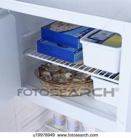 Close-up of freezer compartment of fridge with door open View Large Photo Image Stock Photo - Close-up of freezer compartment of fridge with door open . Fotosearch