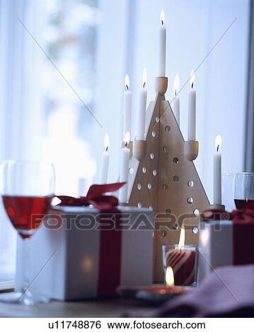 Stock Photograph - Close-up of lighted candles in Christmas-tree shaped candleholder. Fotosearch