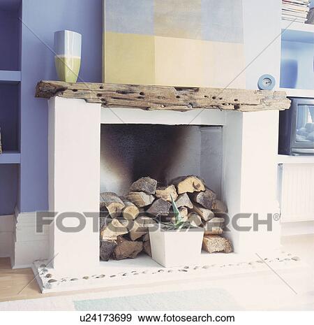 Close-up of logs in modern fireplace with driftwood mantlepiece View Large Photo Image Stock Photo - Close-up of logs in modern fireplace with driftwood mantlepiece . Fotosearch