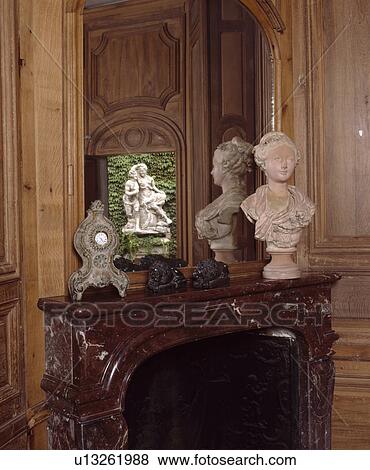 Stock Photo - Close-up of mirror above classical bust on mantelpiece. Fotosearch
