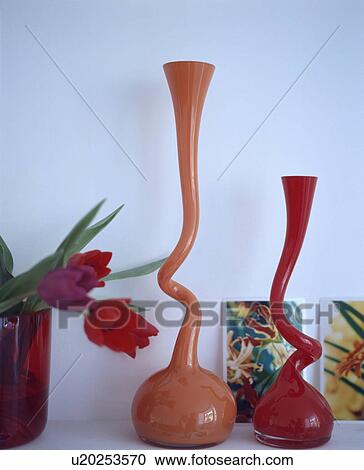Stock Image - Close-up of modern orange glass vases. Fotosearch