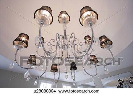 Close-up of modern stainless steel chandelier with lampshades and glass teardrops View Large Photo Image Picture - Close-up of modern stainless steel chandelier with lampshades and glass teardrops. Fotosearch