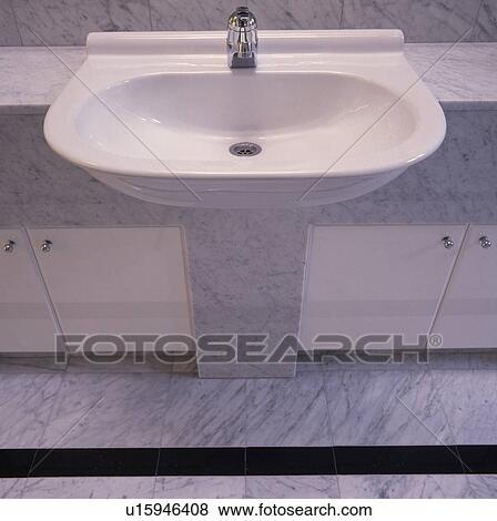 Close-up of modern white basin in grey and white vanity unit View Large Photo Image Stock Photo - Close-up of modern white basin in grey and white vanity unit. Fotosearch