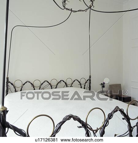 Close-up of modern wrought metal bed with white bedcover View Large Photo Image Stock Image - Close-up of modern wrought metal bed with white bedcover. Fotosearch