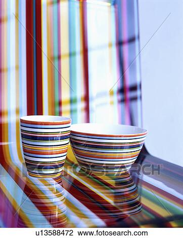 Close-up of multi-coloured striped bowls on matching striped perspex chair View Large Photo Image Stock Image - Close-up of multi-coloured striped bowls on matching striped perspex chair. Fotosearch