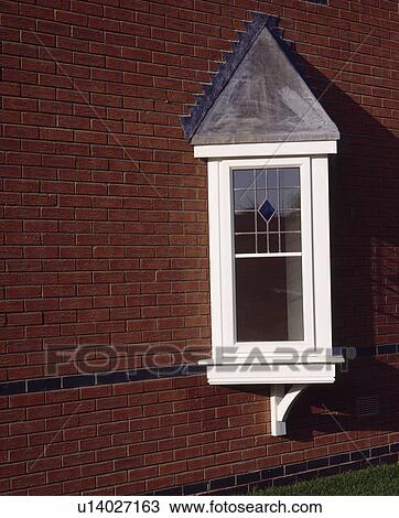 Stock Image - Close up of newbuild traditional Oriel window. Fotosearch