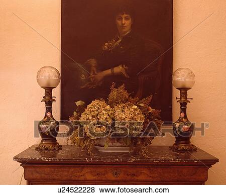 Close-up of oil portrait above Victorian glass lamps and dried flower arrangement View Large Photo Image Stock Photo - Close-up of oil portrait above Victorian glass lamps and dried flower arrangement. Fotosearch