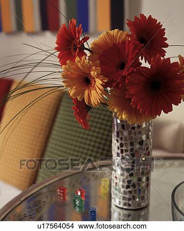 Close-up of orange and red gerberas in mosaic glass vase on glass table View Large Photo Image Picture - Close-up of orange and red gerberas in mosaic glass vase on glass table. Fotosearch