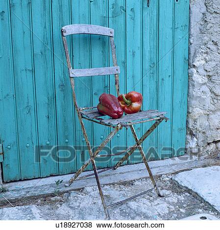 Close-up of peppers on old garden chair in front of turquoise wooden door View Large Photo Image Stock Photo - Close-up of peppers on old garden chair in front of turquoise wooden door. Fotosearch