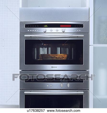 Close-up of pie cooking in double stainless steel oven with glass door View Large Photo Image Stock Photo - Close-up of pie cooking in double stainless steel oven with glass door . Fotosearch