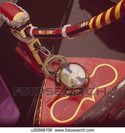 Close up of red and yellow striped wooden tiller on stern of traditional narrow boat with painted metal pan View Large Photo Image Stock Photograph - Close up of red and yellow striped wooden tiller on stern of traditional narrow boat with painted metal pan. Fotosearch