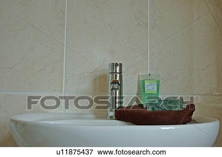 Close-up of smodern chrome tap above white ceramic basin View Large Photo Image Stock Photo - Close-up of smodern chrome tap above white ceramic basin. Fotosearch