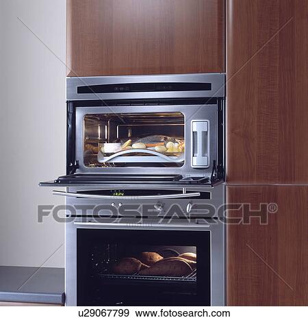 Stock Photo - Close-up of stainless steel double oven in modern wood kitchen unit&#13; &#10; &#13; &#10; &#13; &#10; &#13; &#10; &#13; &#10; &#13; &#10;. Fotosearch