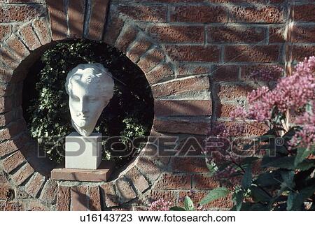 Close up of stone sculpture of head in circular alcove in brick wall View Large Photo Image Stock Image - Close up of stone sculpture of head in circular alcove in brick wall. Fotosearch