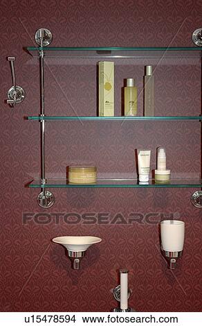 Close-up of toiletries and cosmetics on modern glass shelves View Large Photo Image Picture - Close-up of toiletries and cosmetics on modern glass shelves. Fotosearch