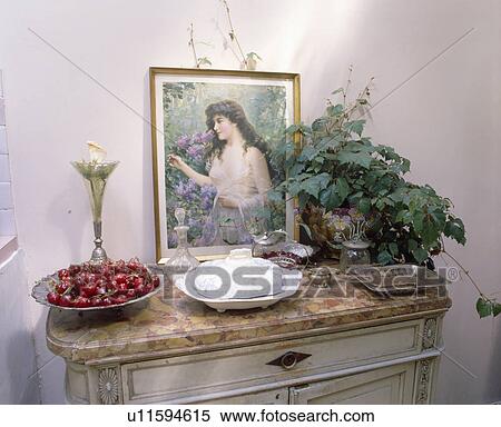 Close-up of Victorian picture and houseplant on marble-topped cupboard View Large Photo Image Stock Photography - Close-up of Victorian picture and houseplant on marble-topped cupboard. Fotosearch