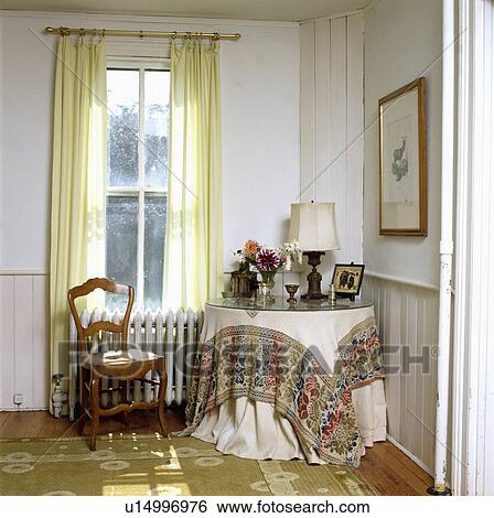 Cloth on circular table in traditional living room View Large Photo Image Stock Photograph - Cloth on circular table in traditional living room. Fotosearch