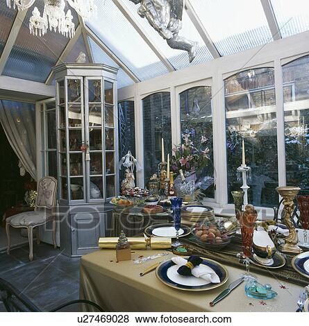 Conservatory dining room with table decorated for Christmas dinner View Large Photo Image Stock Photo - Conservatory dining room with table decorated for Christmas dinner. Fotosearch