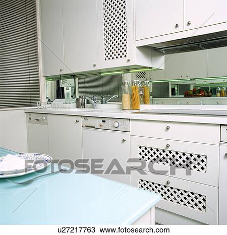 Contemporary white kitchen with blue glass counter and mirrored splashback View Large Photo Image Stock Image - Contemporary white kitchen with blue glass counter and mirrored splashback. Fotosearch