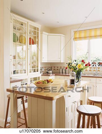 Contemporary white painted wooden kitchen with island unit incorporating breakfast bar. View Large Photo Image Stock Photography - Contemporary white painted wooden kitchen with island unit incorporating breakfast bar.. Fotosearch
