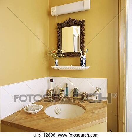 Stock Images Of Corner Yellow Bathroom With Circular White Basin Corner Of Yellow Bathroom With Circular White Basin Built Into Wooden Vanity Unit
