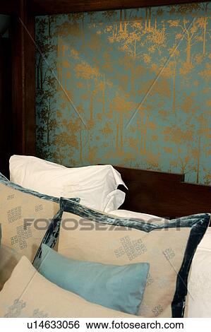 Cream and blue cushions edged with velvet against gold-patterned green wallpaper View Large Photo Image Stock Photograph - Cream and blue cushions edged with velvet against gold-patterned green wallpaper. Fotosearch